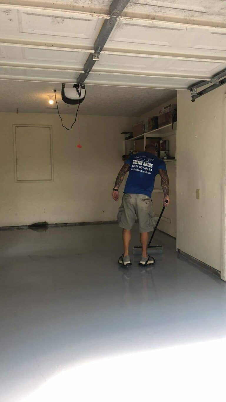 Man smoothing a freshly poured concrete garage floor