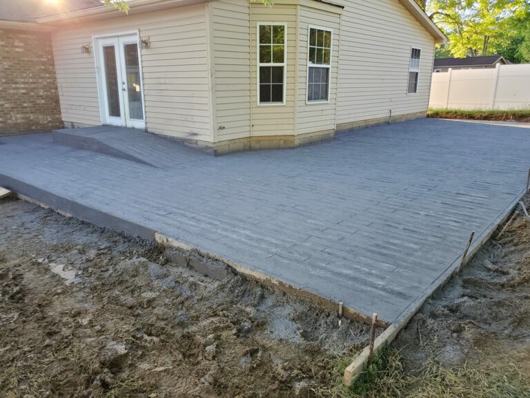 Freshly poured residential concrete patio with stamped plank design